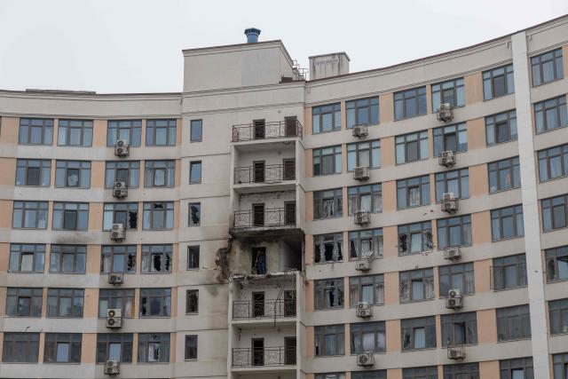A resident sweeps up debris in a damaged residential building at the site of a Russian attack in Odesa on February 17, 2026, amid the Russian invasion of Ukraine. Ukrainian officials in the port city of Odesa reported on February 17, 2026, damage to buildings and at least two wounded after a drone attack overnight. (Photo by Oleksandr GIMANOV / AFP)