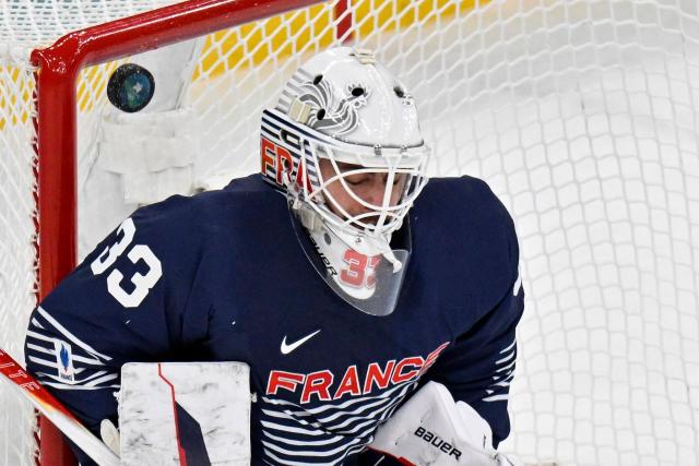 France's #33 Julian Junca fails to save the puck during the men's qualification play-off ice hockey match between Germany and France at the Milano Santagiulia Ice Hockey Arena during the Milano Cortina 2026 Winter Olympic Games in Milan, on February 17, 2026. (Photo by Alexander NEMENOV / AFP)