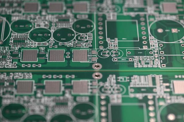 This photograph shows printed circuit boards at an assembly line of Syselec group's factory in Castres, southwestern France, on February 17, 2026. (Photo by Lionel BONAVENTURE / AFP)