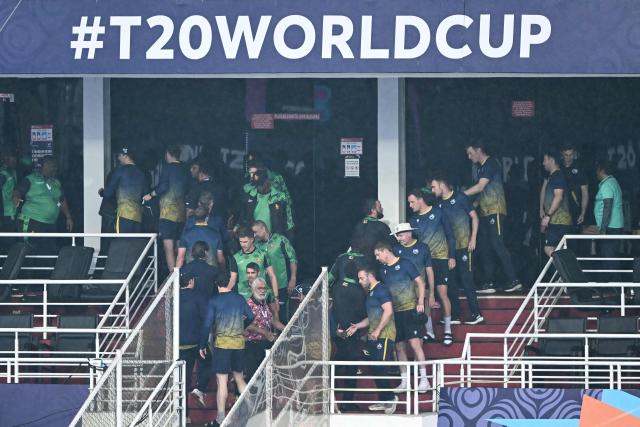 Zimbabwe and Ireland team players shake hands after their 2026 ICC Men's T20 Cricket World Cup group stage match was called off due to rain at Pallekele International Cricket Stadium in Kandy on February 17, 2026. (Photo by Ishara S. KODIKARA / AFP)