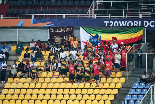 Fans of team Zimbabwe cheer as the 2026 ICC Men's T20 Cricket World Cup group stage match between Zimbabwe and Ireland was called off due to rain at Pallekele International Cricket Stadium in Kandy on February 17, 2026. (Photo by Ishara S. KODIKARA / AFP)