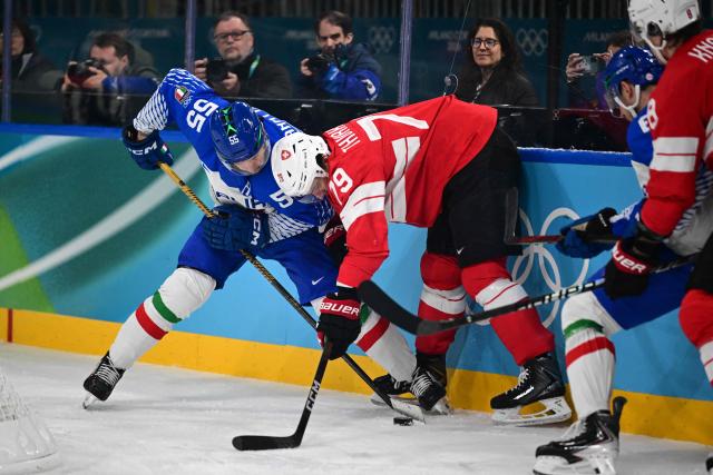 Italy's #55 Luca Zanatta fights for the puck with Switzerland's #79 Calvin Thurkauf during the men's qualification play-off ice hockey match between Switzerland and Italy during the Milano Cortina 2026 Winter Olympic Games at the Milano Rho Ice Hockey Arena in Milan, on February 17, 2026. (Photo by Piero CRUCIATTI / AFP)