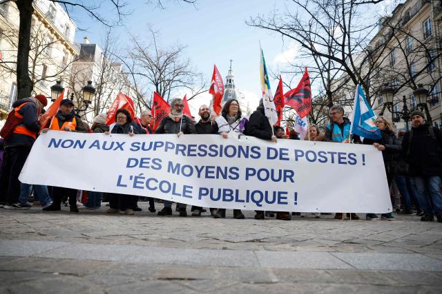 Paris' Ile-de-France region teachers take part in a demonstration called by several unions against the 2026 state budget and planned teaching post cuts, outside the Sorbonne University in Paris on February 17, 2026. (Photo by Charlotte SIEMON / AFP)