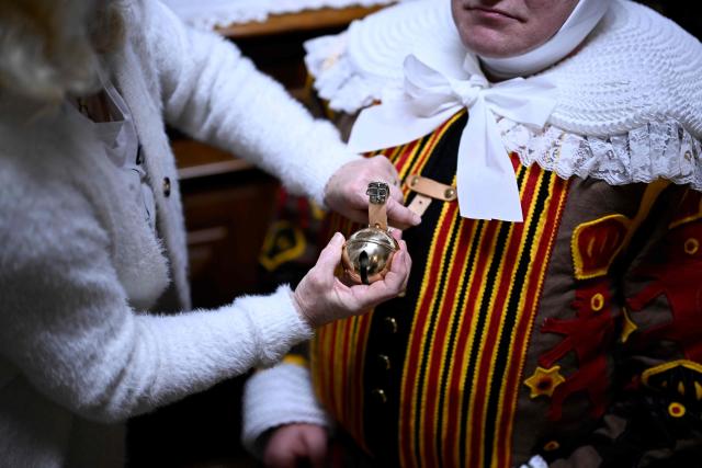 A carnival goer gets help dressing up as Gilles de Binche, the oldest and principal participants in the Carnival of Binche, before the parade in Binche on February 17, 2026. The Binche Carnival tradition is one of the most ancient and representative of Wallonia and inscribed in 2008 on the Representative List of the Intangible Cultural Heritage of Humanity by UNESCO. (Photo by JOHN THYS / AFP)