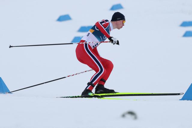 Norway's Jens Luraas Oftebro competes in the cross-country event of the nordic combined individual Gundersen large hill/10km at Tesero Cross Country Stadium at Lago di Tesero (Val di Fiemme) during the Milano Cortina 2026 Winter Olympic Games on February 17, 2026. (Photo by Anne-Christine POUJOULAT / AFP)