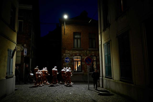 Carnival goers dressed up as Gilles de Binche, the oldest and principal participants in the Carnival of Binche, parade in Binche on February 17, 2026. The Binche Carnival tradition is one of the most ancient and representative of Wallonia and inscribed in 2008 on the Representative List of the Intangible Cultural Heritage of Humanity by UNESCO. (Photo by JOHN THYS / AFP)