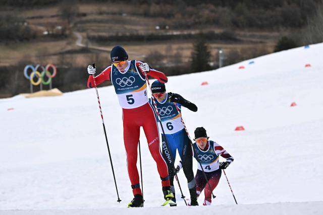 (From L) Norway's Jens Luraas Oftebro, Estonia's Kristjan Ilves and Austria's Thomas Rettenegger compete in the cross-country event of the nordic combined individual Gundersen large hill/10km at Tesero Cross Country Stadium at Lago di Tesero (Val di Fiemme) during the Milano Cortina 2026 Winter Olympic Games on February 17, 2026. (Photo by Javier SORIANO / AFP)