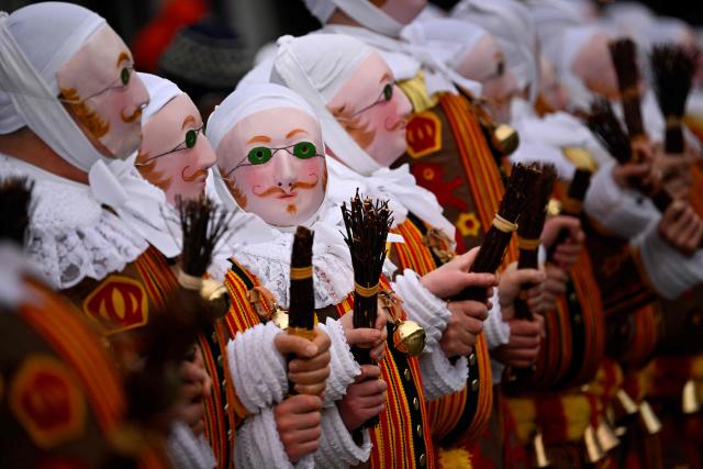 Carnival goers dressed up as Gilles de Binche, the oldest and principal participants in the Carnival of Binche, parade in Binche on February 17, 2026. The Binche Carnival tradition is one of the most ancient and representative of Wallonia and inscribed in 2008 on the Representative List of the Intangible Cultural Heritage of Humanity by UNESCO. (Photo by JOHN THYS / AFP)