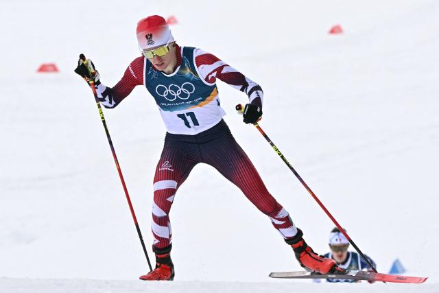 Austria's Stefan Rettenegger competes in the cross-country event of the nordic combined individual Gundersen large hill/10km at Tesero Cross Country Stadium at Lago di Tesero (Val di Fiemme) during the Milano Cortina 2026 Winter Olympic Games on February 17, 2026. (Photo by Javier SORIANO / AFP)