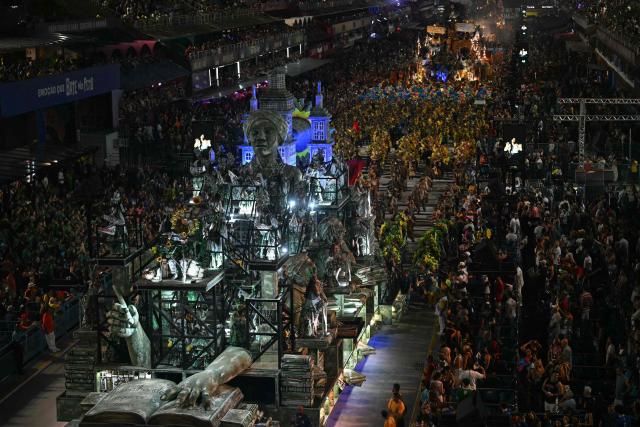 Revellers of the Unidos da Tijuca samba school perform during the second night of the Rio Carnival at the Marques de Sapucai Sambadrome in Rio de Janeiro, Brazil, early on February 17, 2026. (Photo by Mauro PIMENTEL / AFP)