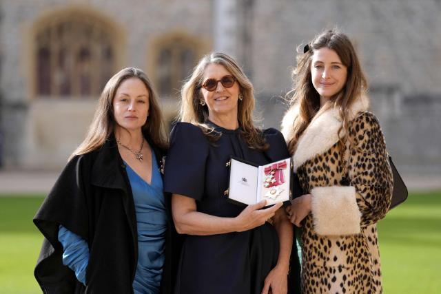 Emma Bridgewater (C) poses alongside her daughters with her medal and insignia after being appointed a Dame Commander of the Order of the British Empire (DBE) at an investiture ceremony at Windsor Castle, in Windsor February 17, 2026.  (Photo by Andrew Matthews / POOL / AFP)