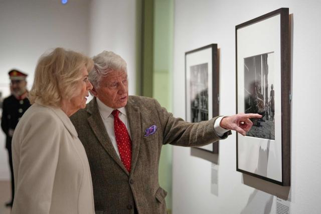 Britain's Queen Camilla (L) speaks to veteran British photographer Don McCullin as she pays a visit to the recently completed Schroder Gallery, which displays some of his photography, at the Holburne Museum in Bath, south-west England on February 17, 2026. (Photo by Alastair Grant / POOL / AFP)