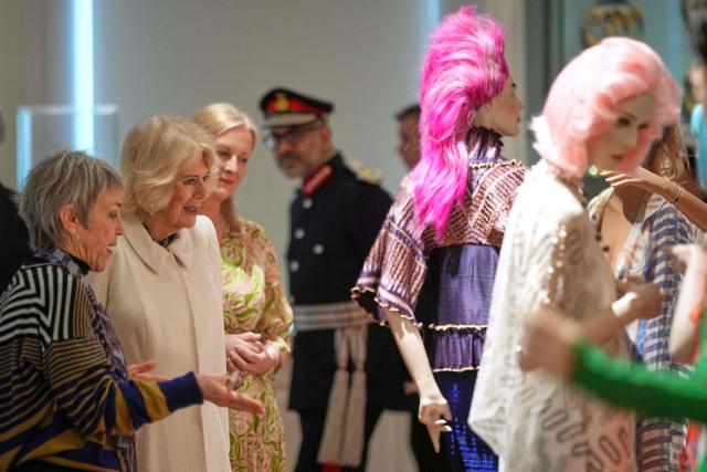 Britain's Queen Camilla (2nd L) and Rosemary Harding (L) visit the recently completed Schroder Gallery, featuring the colourful textiles of fashion designer Zandra Rhodes, at the Holburne Museum in Bath, south-west England on February 17, 2026. (Photo by Alastair Grant / POOL / AFP)