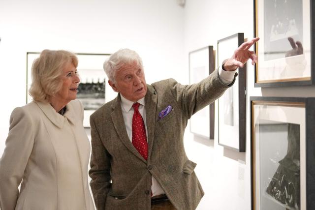Britain's Queen Camilla (L) speaks to veteran British photographer Don McCullin as she pays a visit to the recently completed Schroder Gallery, which displays some of his photography, at the Holburne Museum in Bath, south-west England on February 17, 2026. (Photo by Alastair Grant / POOL / AFP)
