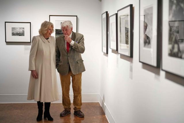 Britain's Queen Camilla (L) speaks to veteran British photographer Don McCullin as she pays a visit to the recently completed Schroder Gallery, which displays some of his photography, at the Holburne Museum in Bath, south-west England on February 17, 2026. (Photo by Alastair Grant / POOL / AFP)