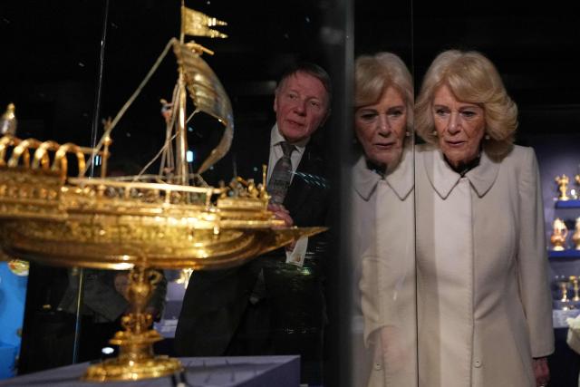 Britain's Queen Camilla is reflected in the glass as she visits the recently completed Schroder Gallery at the Holburne Museum in Bath, south-west England on February 17, 2026. (Photo by Alastair Grant / POOL / AFP)