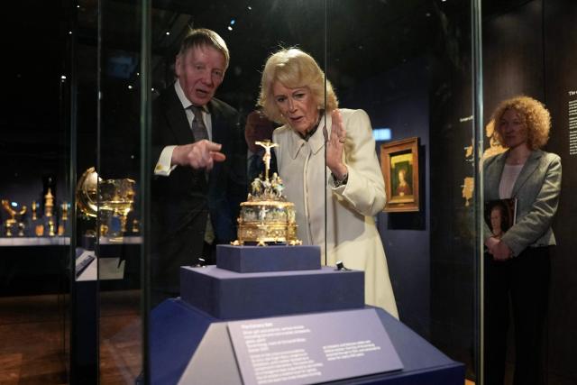 Tim Schroder (L) explains objects to Britain's Queen Camilla as she visits the recently completed Schroder Gallery at the Holburne Museum in Bath, south-west England on February 17, 2026. (Photo by Alastair Grant / POOL / AFP)