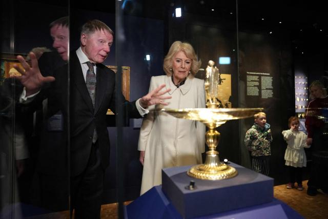 Tim Schroder (L) explains objects to Britain's Queen Camilla as she visits the recently completed Schroder Gallery at the Holburne Museum in Bath, south-west England on February 17, 2026. (Photo by Alastair Grant / POOL / AFP)
