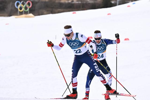USA's Benjamin Loomis (L) and France's Mael Tyrode compete in the cross-country event of the nordic combined individual Gundersen large hill/10km at Tesero Cross Country Stadium at Lago di Tesero (Val di Fiemme) during the Milano Cortina 2026 Winter Olympic Games on February 17, 2026. (Photo by Javier SORIANO / AFP)