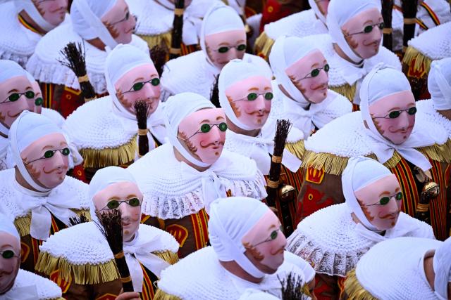 Carnival goers dressed up as Gilles de Binche, the oldest and principal participants in the Carnival of Binche, parade in Binche on February 17, 2026. The Binche Carnival tradition is one of the most ancient and representative of Wallonia and inscribed in 2008 on the Representative List of the Intangible Cultural Heritage of Humanity by UNESCO. (Photo by JOHN THYS / AFP)