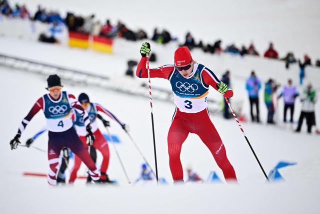 Norway's Andreas Skoglund (R)  competes in the cross-country event of the nordic combined individual Gundersen large hill/10km at Tesero Cross Country Stadium at Lago di Tesero (Val di Fiemme) during the Milano Cortina 2026 Winter Olympic Games on February 17, 2026. (Photo by Tobias SCHWARZ / AFP)