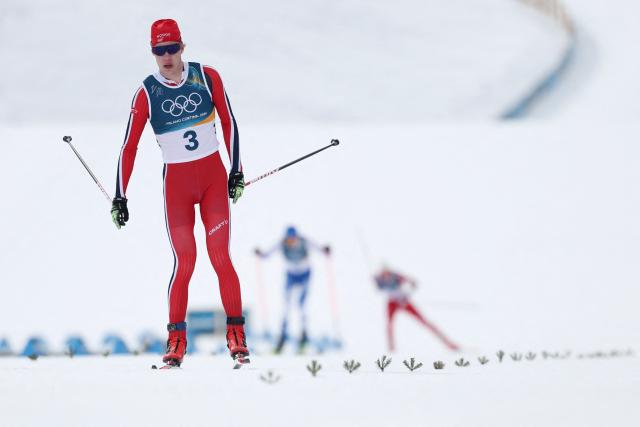 Norway's Andreas Skoglund skis towards the finish line to take fourth place in the cross-country event of the nordic combined individual Gundersen large hill/10km at Tesero Cross Country Stadium at Lago di Tesero (Val di Fiemme) during the Milano Cortina 2026 Winter Olympic Games on February 17, 2026. (Photo by Anne-Christine POUJOULAT / AFP)