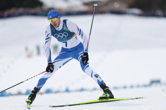 Finland's Ilkka Herola reacts after crossing the finish to win bronze in the cross-country event of the nordic combined individual Gundersen large hill/10km at Tesero Cross Country Stadium at Lago di Tesero (Val di Fiemme) during the Milano Cortina 2026 Winter Olympic Games on February 17, 2026. (Photo by Anne-Christine POUJOULAT / AFP)