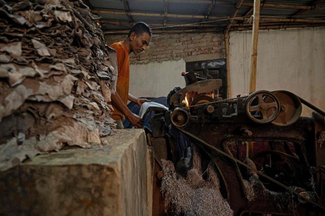 A Bangladeshi labourer processes leather at a tannery in Dhaka on February 17, 2026. (Photo by MOHD RASFAN / AFP)