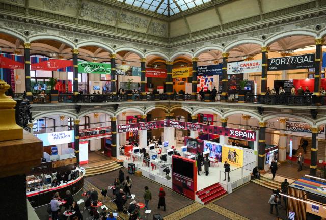 Partial inside view taken on February 17, 2026 in the Martin-Gropius-Bau in Berlin, of booths of film industry professionals at the European Film Market (EFM) is held from February 12 to 18, 2026 on the sidelines of the 76th Berlinale, Europe's first major film festival of the year. The EFM is a trade platform for film rights and audiovisual content. According to the organisers, over 8,300 international industry professionals including almost 1,500 buyers and more than 480 exhibitors, attend the EFM. (Photo by RALF HIRSCHBERGER / AFP)