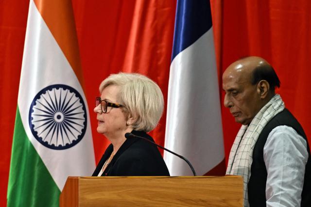 India's Defence Minister Rajnath Singh (R) with his French counterpart Catherine Vautrin attends the virtual inauguration of the final assembly line (FAL) for Airbus H125 helicopter, a joint venture between India's Tata Group and Europe's Airbus, at Vemagal in Kolar district on February 17, 2026. French President Emmanuel Macron will meet Indian Prime Minister Narendra Modi in Mumbai on February 17, as he begins a three-day visit to India focused on artificial intelligence cooperation and a potential multibillion dollar fighter jet deal. (Photo by Idrees MOHAMMED / AFP)