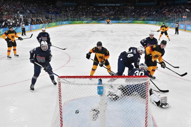 Germany's #44 Joshua Samanski (R) scores his team's fourth goal during the men's qualification play-off ice hockey match between Germany and France at the Milano Santagiulia Ice Hockey Arena during the Milano Cortina 2026 Winter Olympic Games in Milan, on February 17, 2026. (Photo by Alexander NEMENOV / POOL / AFP)