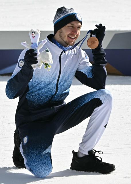 Bronze medallist Finland's Ilkka Herola celebrates on the podium following the nordic combined individual Gundersen large hill/10km event at Tesero Cross Country Stadium at Lago di Tesero (Val di Fiemme) during the Milano Cortina 2026 Winter Olympic Games on February 17, 2026. (Photo by Javier SORIANO / AFP)