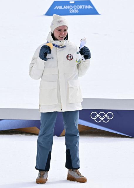 Gold medallist Norway's Jens Luraas Oftebro celebrates on the podium following the nordic combined individual Gundersen large hill/10km event at Tesero Cross Country Stadium at Lago di Tesero (Val di Fiemme) during the Milano Cortina 2026 Winter Olympic Games on February 17, 2026. (Photo by Javier SORIANO / AFP)