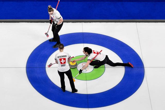 Switzerland's Alina Paetz (L), Switzerland's Selina Witschonke (C) and Switzerland's Carole Howald (L) compete in the curling women's round robin between South Korea and Switzerland during the Milano Cortina 2026 Winter Olympic Games at the Cortina Curling Olympic Stadium in Cortina d’Ampezzo on February 17, 2026. (Photo by Tiziana FABI / AFP)