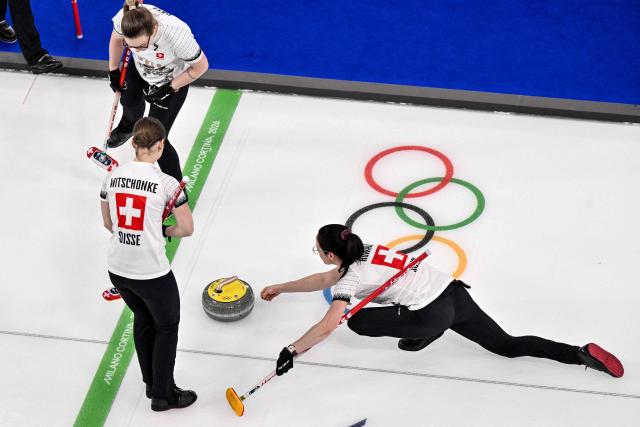 Switzerland's Alina Paetz (L), Switzerland's Selina Witschonke (C) and Switzerland's Carole Howald (L) compete in the curling women's round robin between South Korea and Switzerland during the Milano Cortina 2026 Winter Olympic Games at the Cortina Curling Olympic Stadium in Cortina d’Ampezzo on February 17, 2026. (Photo by Tiziana FABI / AFP)