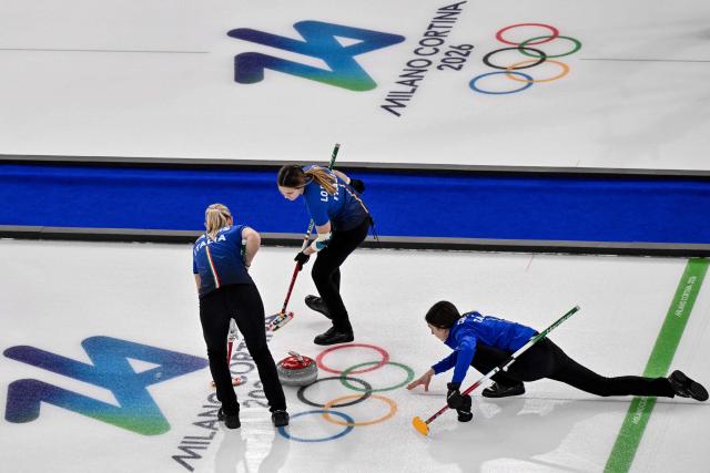 Italy's Elena Mathis (L), Italy's Marta Lo Deserto (C) and Italy's Stefania Constantini (R) compete in the curling women's round robin between Italy and Japan during the Milano Cortina 2026 Winter Olympic Games at the Cortina Curling Olympic Stadium in Cortina d’Ampezzo on February 17, 2026. (Photo by Tiziana FABI / AFP)