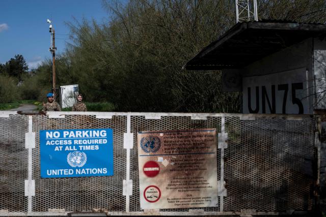 Members of the United Nations Peacekeeping Force in Cyprus (UNFICYP) approach a gate to leave after patrolling the buffer zone separating the internationally recognized Republic of Cyprus and the breakaway Turkish Republic of Northern Cyprus — recognized only by Ankara — in the divided capital Nicosia on February 17, 2026. Cyprus has been divided since 1974, when a Turkish invasion followed a coup in Nicosia backed by Greece’s then military junta. The Turkish Republic of Northern Cyprus, declared in 1983, is recognized only by Ankara, while the internationally recognized Republic of Cyprus — a member of the European Union — controls the island’s majority Greek Cypriot south. There are currently nine crossings along the UN-patrolled Green Line separating the two sides, and calls have grown for additional crossings along the 180-kilometre (110-mile) buffer zone to ease access for people in remote areas. Thousands cross daily for work, education or medical care using the crossings operational since 2003, while reunification efforts brokered by the United Nations have remained frozen since talks collapsed in 2017. (Photo by Jewel SAMAD / AFP)