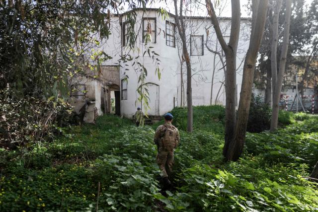Members of the UN Peacekeeping Force in Cyprus (UNFICYP), from the British Army’s 1st Battalion Coldstream Guards, No. 2 Company, patrol along the buffer zone separating the internationally recognized Republic of Cyprus and the breakaway Turkish Republic of Northern Cyprus in the divided capital Nicosia on February 17, 2026. Cyprus has been divided since 1974, when a Turkish invasion followed a coup in Nicosia backed by Greece’s then military junta. The Turkish Republic of Northern Cyprus, declared in 1983, is recognized only by Ankara, while the internationally recognized Republic of Cyprus — a member of the European Union — controls the island’s majority Greek Cypriot south. There are currently nine crossings along the UN-patrolled Green Line separating the two sides, and calls have grown for additional crossings along the 180-kilometre (110-mile) buffer zone to ease access for people in remote areas. Thousands cross daily for work, education or medical care using the crossings operational since 2003, while reunification efforts brokered by the United Nations have remained frozen since talks collapsed in 2017. (Photo by Jewel SAMAD / AFP)