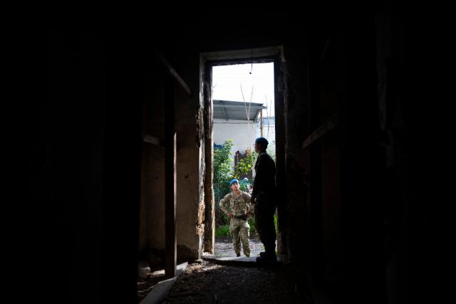 Members of the UN Peacekeeping Force in Cyprus (UNFICYP), from the British Army’s 1st Battalion Coldstream Guards, No. 2 Company, patrol along the buffer zone separating the internationally recognized Republic of Cyprus and the breakaway Turkish Republic of Northern Cyprus in the divided capital Nicosia on February 17, 2026. Cyprus has been divided since 1974, when a Turkish invasion followed a coup in Nicosia backed by Greece’s then military junta. The Turkish Republic of Northern Cyprus, declared in 1983, is recognized only by Ankara, while the internationally recognized Republic of Cyprus — a member of the European Union — controls the island’s majority Greek Cypriot south. There are currently nine crossings along the UN-patrolled Green Line separating the two sides, and calls have grown for additional crossings along the 180-kilometre (110-mile) buffer zone to ease access for people in remote areas. Thousands cross daily for work, education or medical care using the crossings operational since 2003, while reunification efforts brokered by the United Nations have remained frozen since talks collapsed in 2017. (Photo by Jewel SAMAD / AFP)