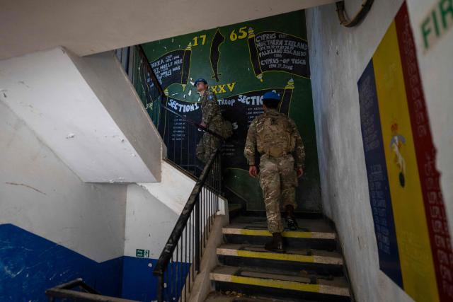 Members of the UN Peacekeeping Force in Cyprus (UNFICYP), from the British Army’s 1st Battalion Coldstream Guards, No. 2 Company, patrol along the buffer zone separating the internationally recognized Republic of Cyprus and the breakaway Turkish Republic of Northern Cyprus in the divided capital Nicosia on February 17, 2026. Cyprus has been divided since 1974, when a Turkish invasion followed a coup in Nicosia backed by Greece’s then military junta. The Turkish Republic of Northern Cyprus, declared in 1983, is recognized only by Ankara, while the internationally recognized Republic of Cyprus — a member of the European Union — controls the island’s majority Greek Cypriot south. There are currently nine crossings along the UN-patrolled Green Line separating the two sides, and calls have grown for additional crossings along the 180-kilometre (110-mile) buffer zone to ease access for people in remote areas. Thousands cross daily for work, education or medical care using the crossings operational since 2003, while reunification efforts brokered by the United Nations have remained frozen since talks collapsed in 2017. (Photo by Jewel SAMAD / AFP)