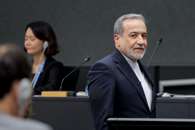 Iran's Foreign Minister Abbas Araghchi looks on upon his arrival to deliver a speech during a session of the United Nations Conference on Disarmament, on the sideline of a second round of US-Iranian talks with Washington pushing Tehran to make a deal to limit its nuclear programme, in Geneva, on February 17, 2026. (Photo by Valentin Flauraud / AFP)