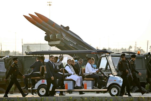 TOPSHOT - India's Defence Minister Rajnath Singh (centre L) with his French counterpart Catherine Vautrin (centre R) takes a tour of the production facility for Airbus H125 helicopters, after its inauguration at Vemagal in Kolar district on February 17, 2026. India's Tata Group and European aviation giant Airbus opened a helicopter final assembly line on February 17, a significant step in New Delhi's flagship "Make in India" drive. The virtual opening was made by Indian Prime Minister Narendra Modi and visiting French President Emmanuel Macron. (Photo by Idrees MOHAMMED / AFP)