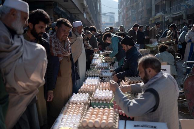 Afghans purchase eggs at a market in Kabul on February 17, 2026 ahead of the Islamic holy fasting month of Ramadan. (Photo by Wakil KOHSAR / AFP)
