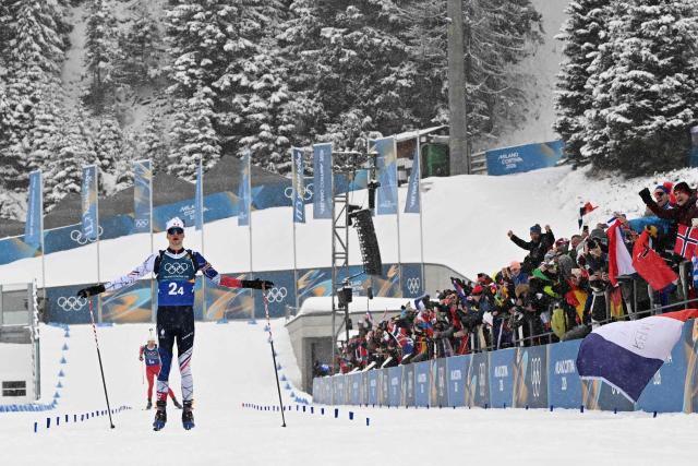 France's Eric Perrot celebrates as he crosses the finish line to win the men's biathlon 4 x 7,5km relay event during the Milano Cortina 2026 Winter Olympic Games at the Anterselva Biathlon Arena (Sudtirol Arena) in Anterselva (Val Pusteria) on February 17, 2026. (Photo by Franck FIFE / AFP)