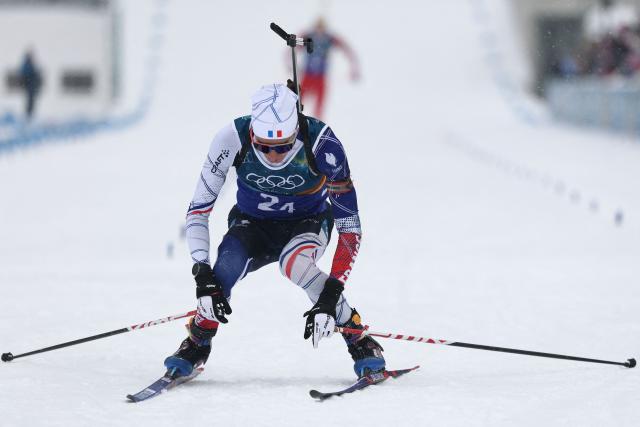 France's Eric Perrot celebrates as he crosses the finish line to win the men's biathlon 4 x 7,5km relay event during the Milano Cortina 2026 Winter Olympic Games at the Anterselva Biathlon Arena (Sudtirol Arena) in Anterselva (Val Pusteria) on February 17, 2026. (Photo by FRANCK FIFE / AFP)
