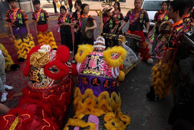People get ready to perform a lion dance outside a restaurant during Lunar New Year celebrations marking the beginning of the Year of the Horse, in Panama City on February 17, 2026. (Photo by MARTIN BERNETTI / AFP)