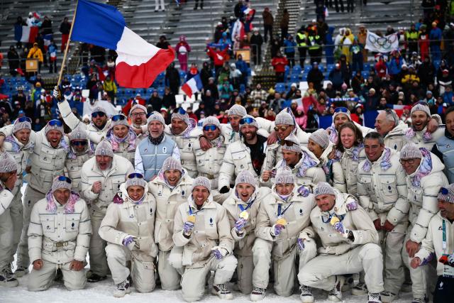Gold medallists (From L) France's Quentin Fillon Maillet, France's Fabien Claude, France's Eric Perrot and France's Emilien Jacquelin celebrate with their team after winning the men's biathlon 4 x 7,5km relay event during the Milano Cortina 2026 Winter Olympic Games at the Anterselva Biathlon Arena (Sudtirol Arena) in Anterselva (Val Pusteria) on February 17, 2026. (Photo by Marco BERTORELLO / AFP)