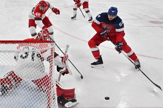 Czech Republic's #64 David Kampf (R) and Denmark's #31 Frederik Andersen vie for the puck during the men's qualification play-off ice hockey match between Czech Republic and Denmark at the Milano Santagiulia Ice Hockey Arena during the Milano Cortina 2026 Winter Olympic Games in Milan, on February 17, 2026. (Photo by Alexander NEMENOV / POOL / AFP)