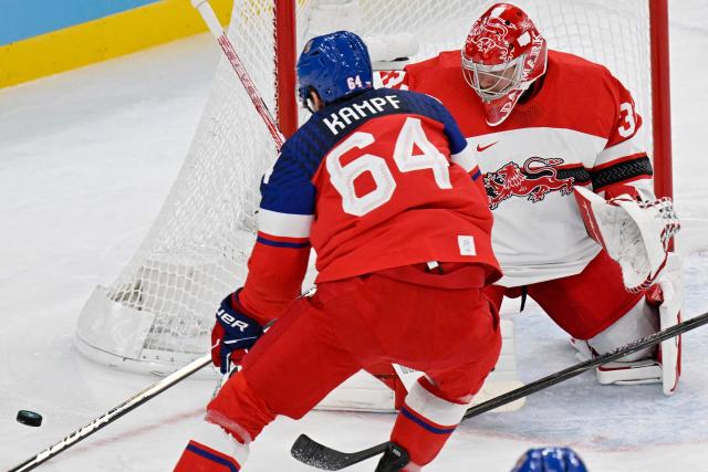 Czech Republic's #64 David Kampf (L) and Denmark's #31 Frederik Andersen (R) vie for the puck during the men's qualification play-off ice hockey match between Czech Republic and Denmark at the Milano Santagiulia Ice Hockey Arena during the Milano Cortina 2026 Winter Olympic Games in Milan, on February 17, 2026. (Photo by Alexander NEMENOV / AFP)