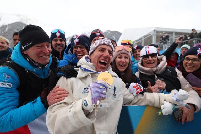 Gold medallist France's Quentin Fillon Maillet celebrates after competing in the men's biathlon 4 x 7,5km relay event during the Milano Cortina 2026 Winter Olympic Games at the Anterselva Biathlon Arena (Sudtirol Arena) in Anterselva (Val Pusteria) on February 17, 2026. (Photo by FRANCK FIFE / AFP)